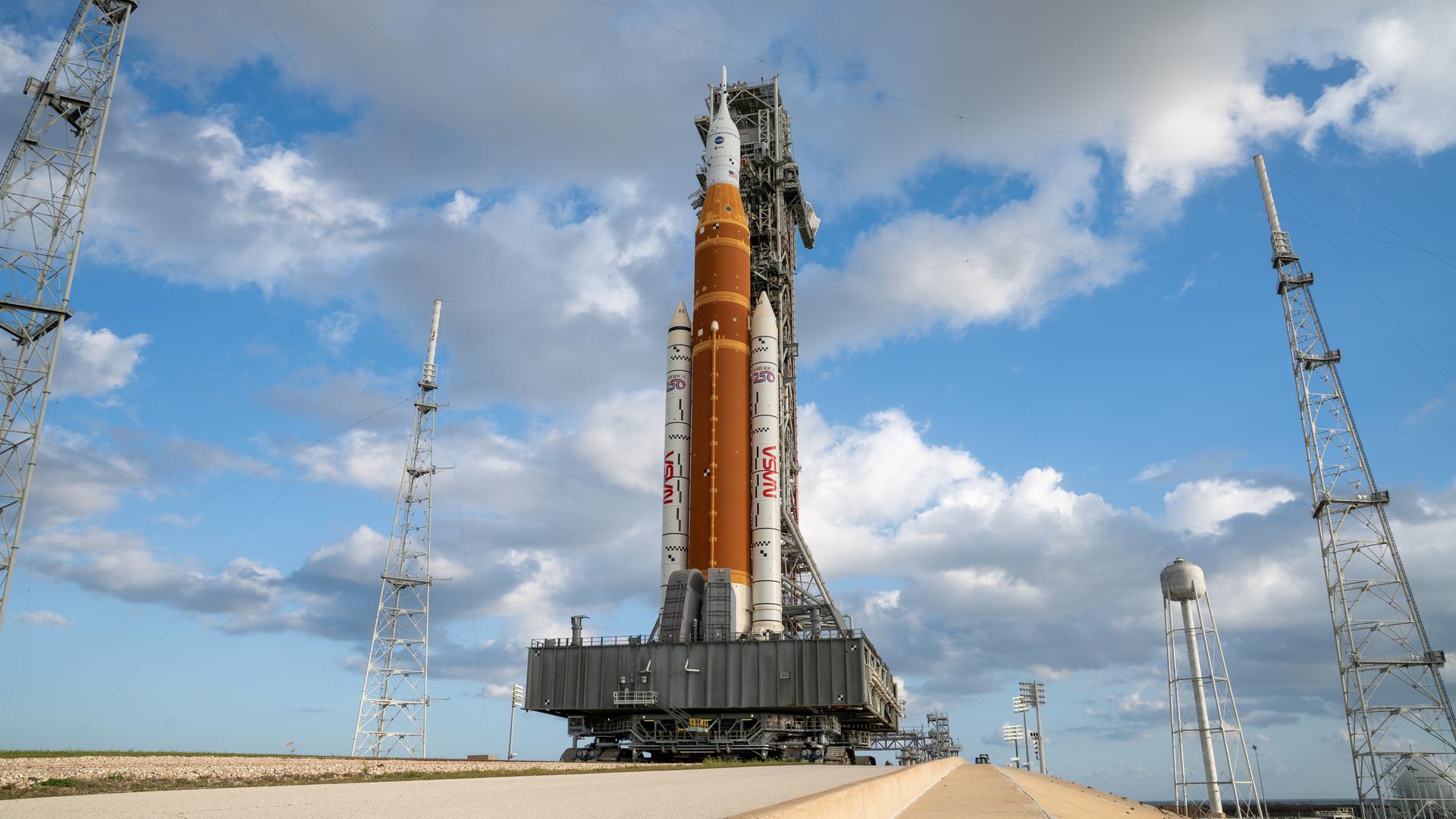 This image shows NASA’s SLS (Space Launch System) and Orion spacecraft rolling out of the Vehicle Assembly Building at NASA’s Kennedy Space Center. NASA's massive Crawler-Transporter, upgraded for the Artemis program, carries the powerful SLS rocket and Orion spacecraft on the Mobile Launcher from the Vehicle Assembly Building to Launch Pad 39B at Kennedy Space Center in preparation for the Artemis II mission. 